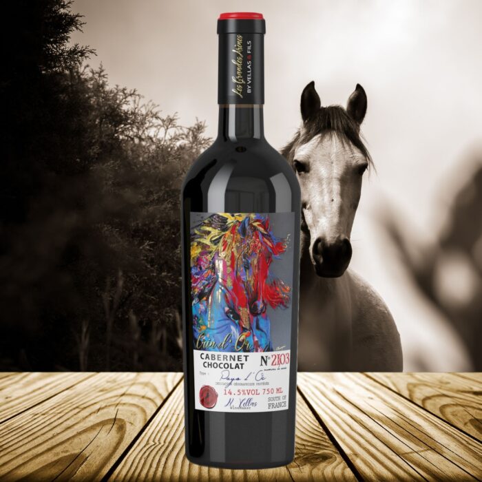 Crin d’Or Cabernet Chocolat Flasche mit Künstleretikett von Anabelle Marquis vor Pferd im Hintergrund